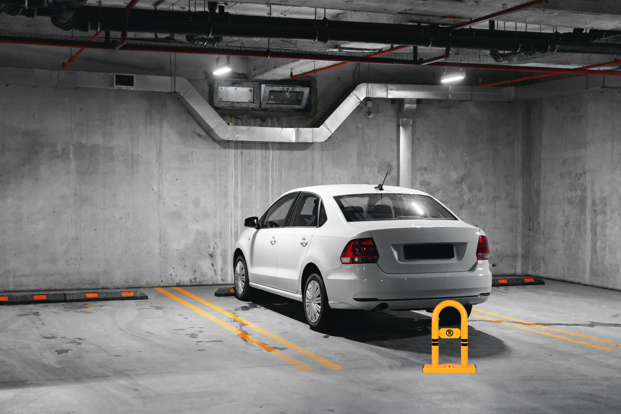 parking barrier infront a car in parking lot